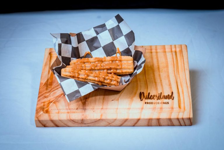 Mini churros espolvoreados con azúcar servidos en bandeja para evento infantil